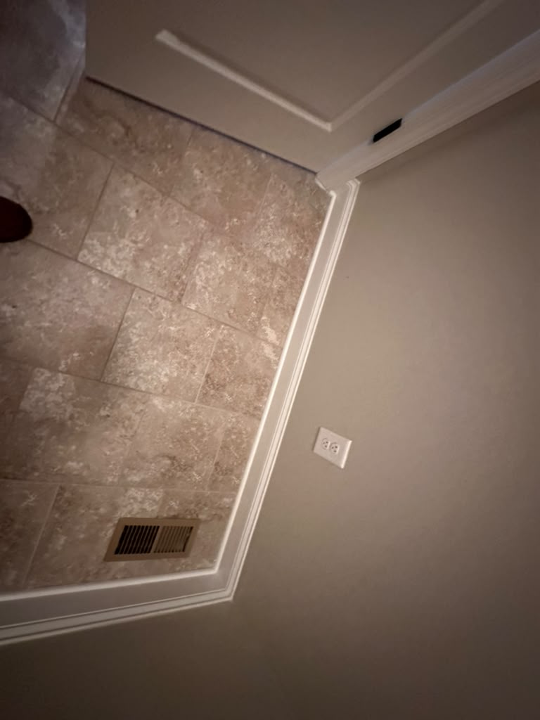 The floor before replacement, with dated beige travertine-look tile