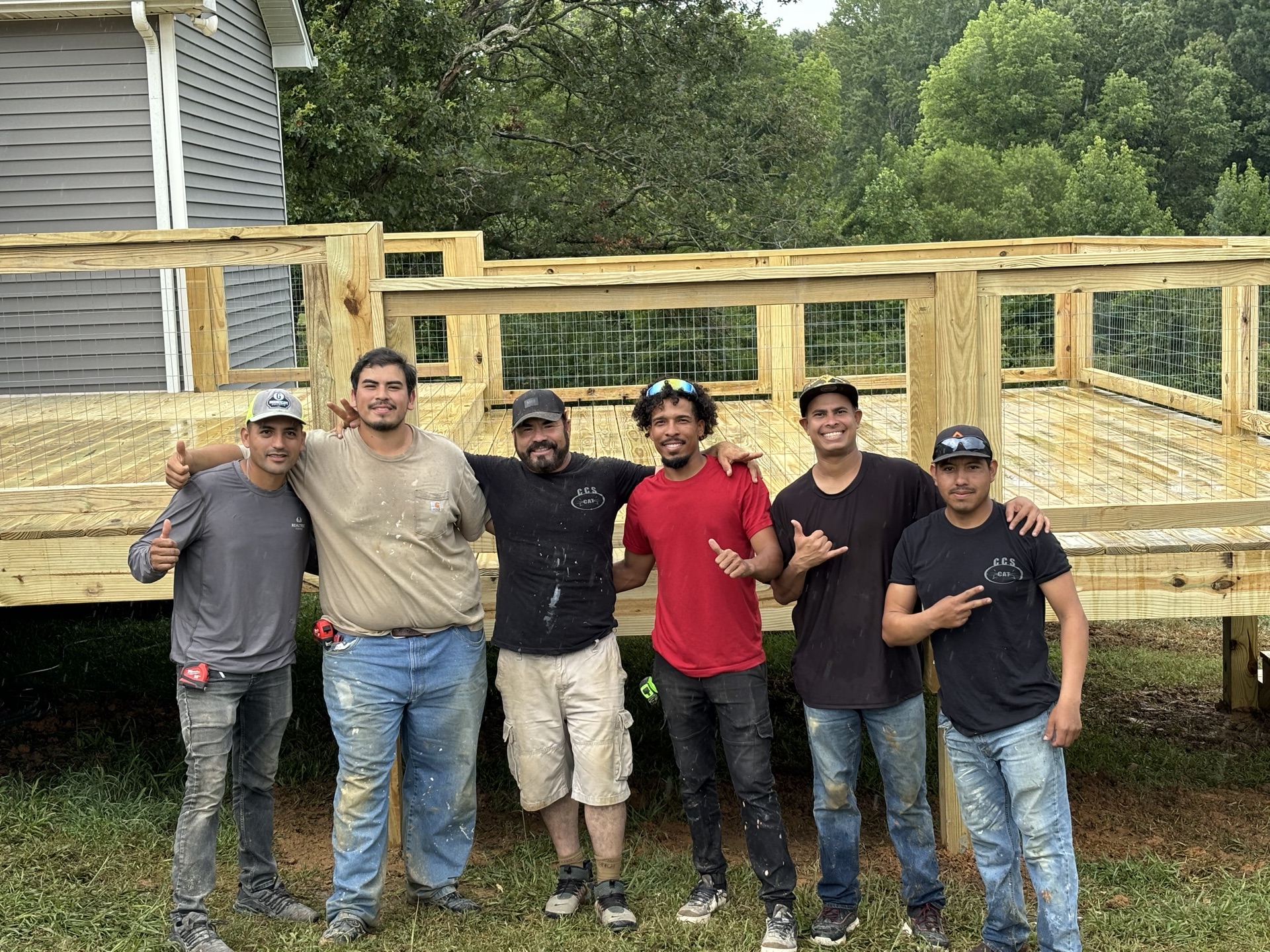 The RRG crew in front of a completed pressure-treated deck