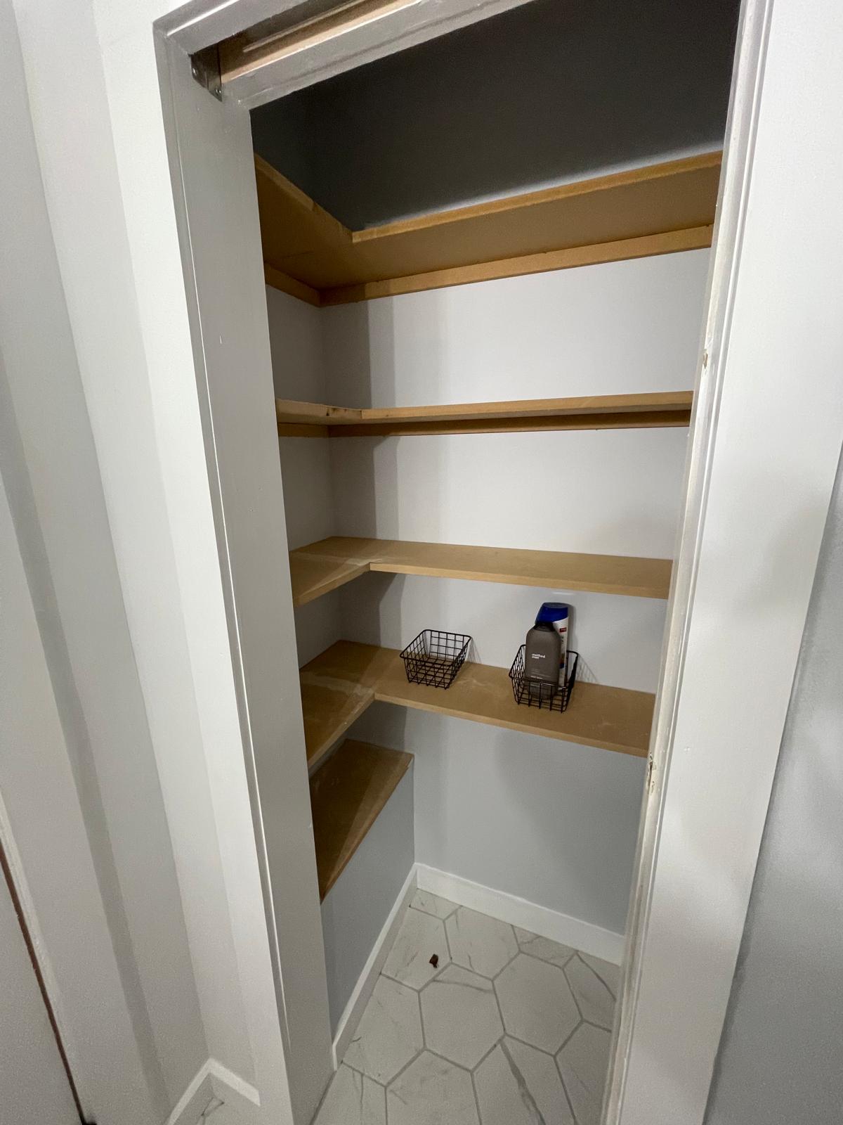 Linen closet with custom wood shelving